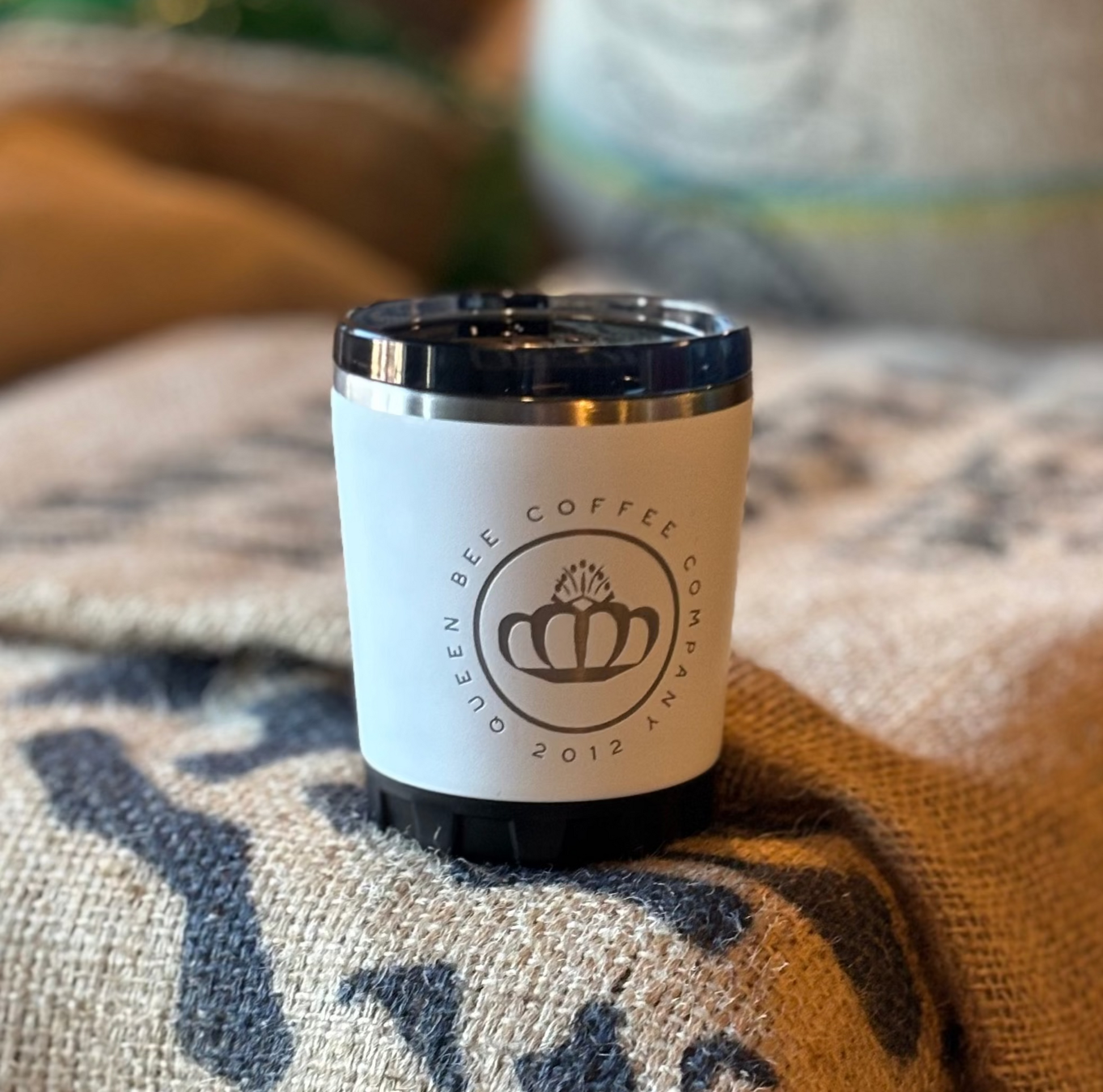Coffee cup with a visible brand logo on a textured surface
