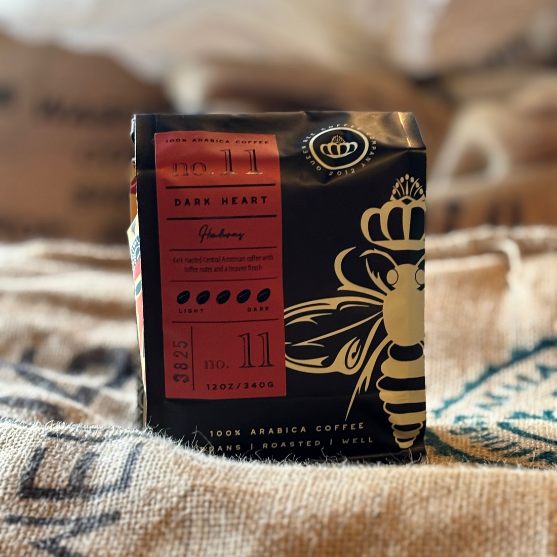 Fresh-roasted Queen Bee Coffee beans in a coffee bag