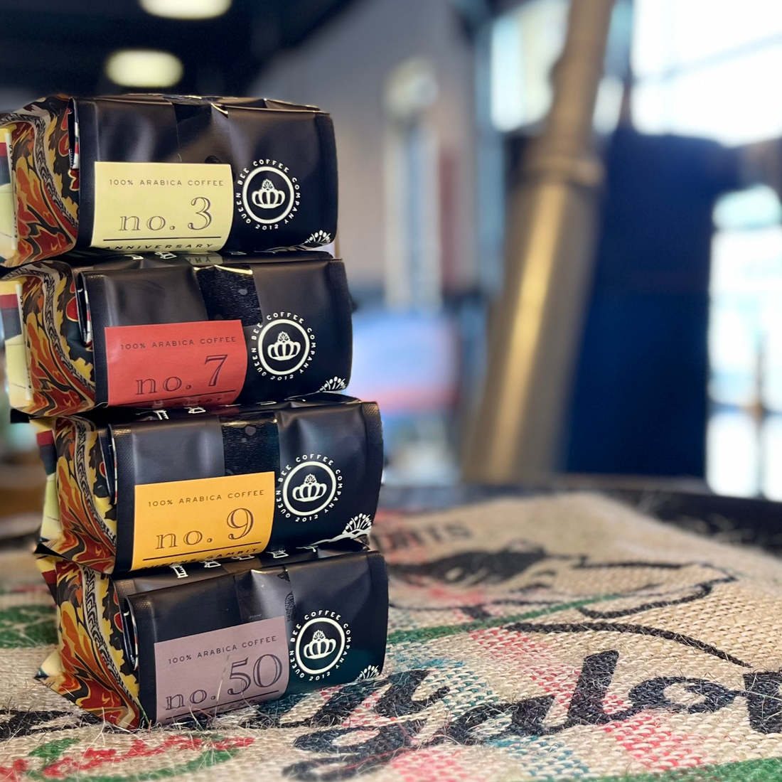 Queen Bee Coffee bags showing different roast levels and flavor profiles