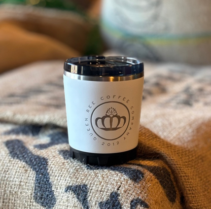 Coffee cup with a visible brand logo on a textured surface